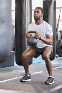 black-man-gym-kettlebell-squat-600nw-2267710063