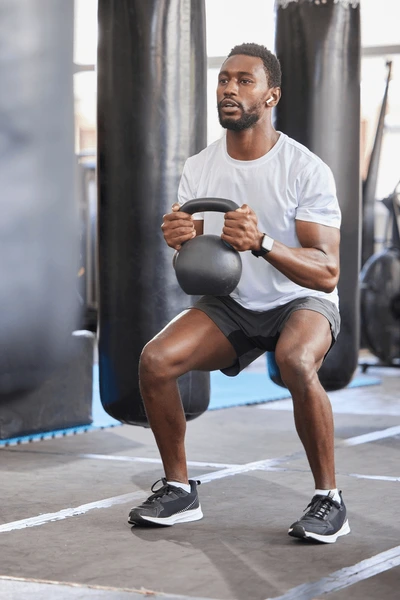 black-man-gym-kettlebell-squat-600nw-2267710063