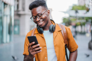 Shot of a young man using mobile phone outdoor in the city.